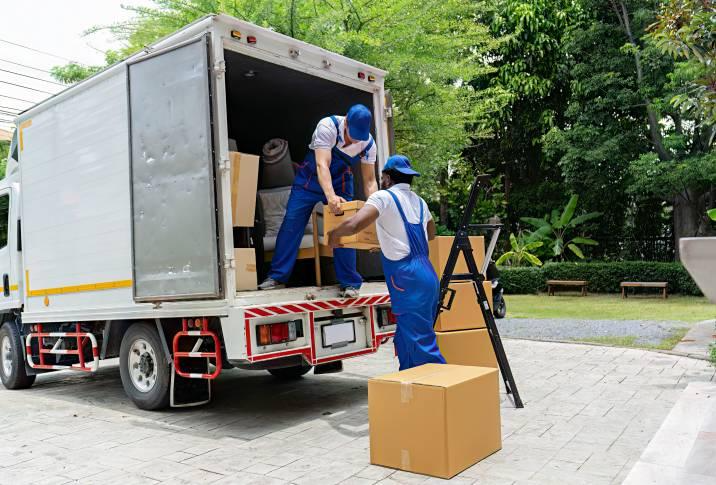 two men loading boxes into a truck