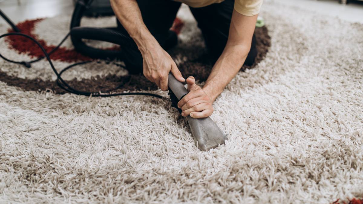 a woman vacuuming a carpet