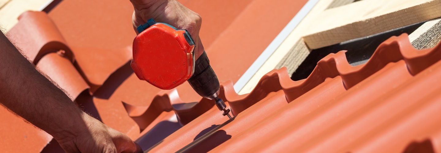 A worker installing a new roof on a house.