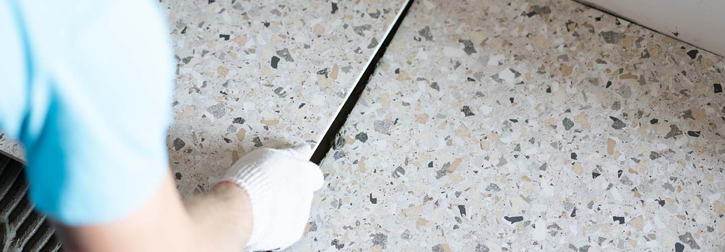 Tile installation of Terrazzo flooring with a mix of colorful chips embedded in a smooth, polished surface. 