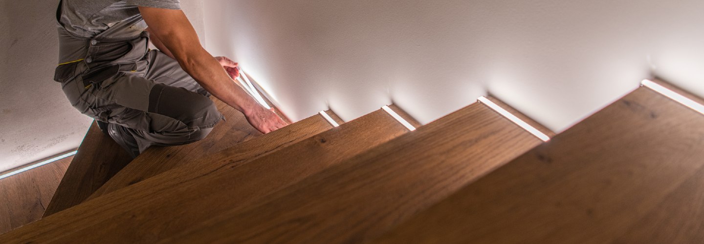 A beautifully renovated wooden staircase with white painted risers.