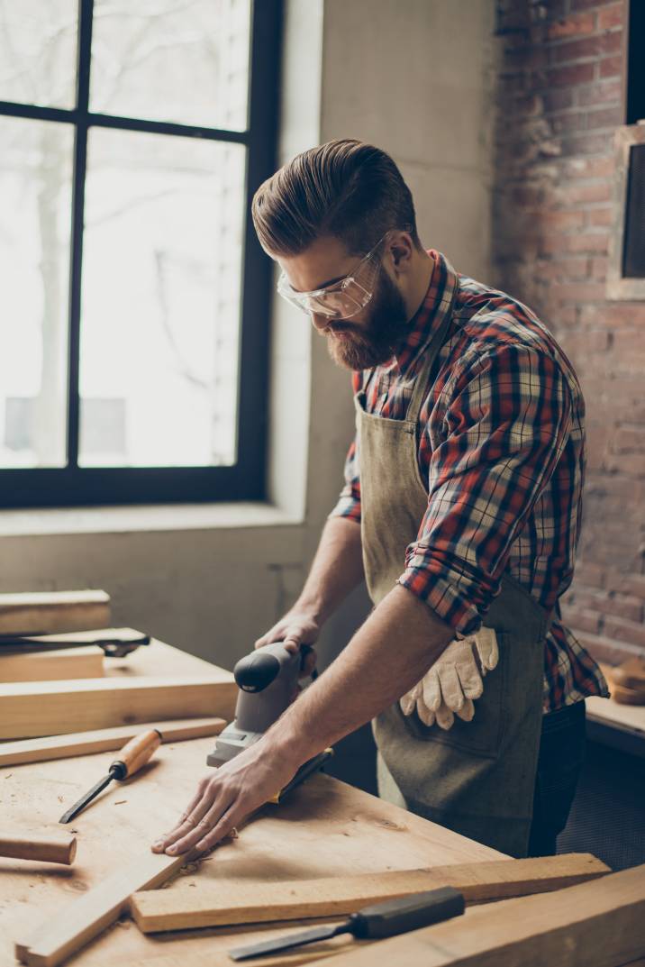 a male woodworker completing a project