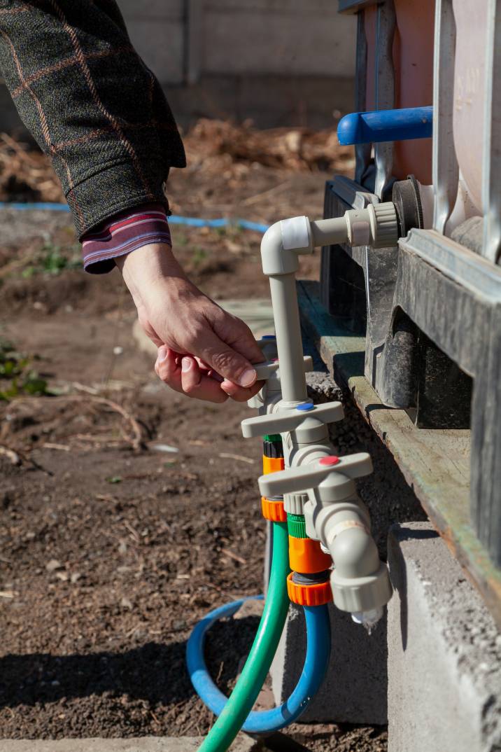 a man opening the valves of an irrigation system