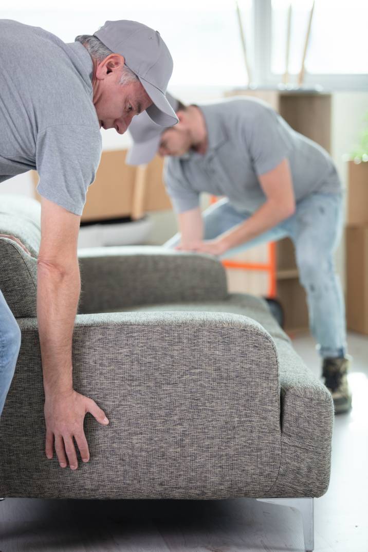 furniture movers preparing to lift a couch
