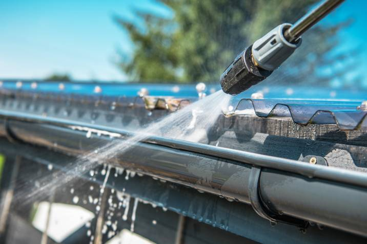 cleaning gutters with a pressure washer