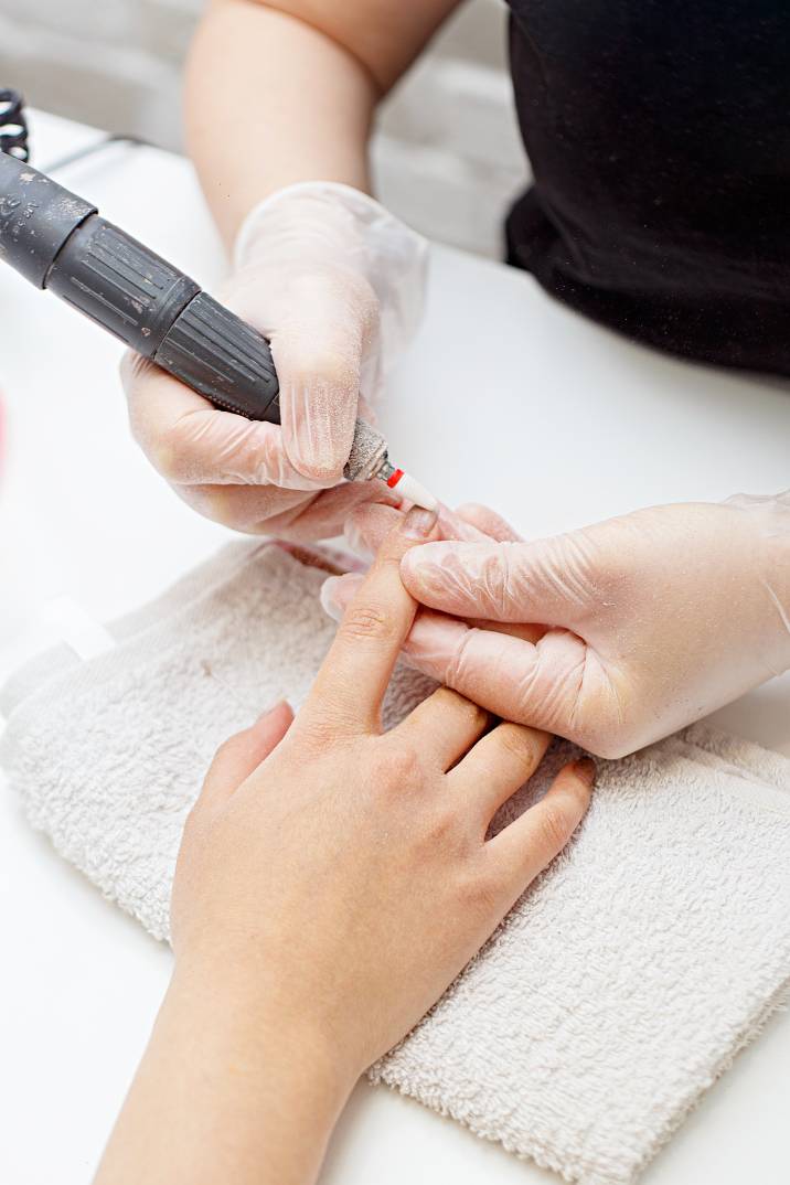 a woman receiving a manicure