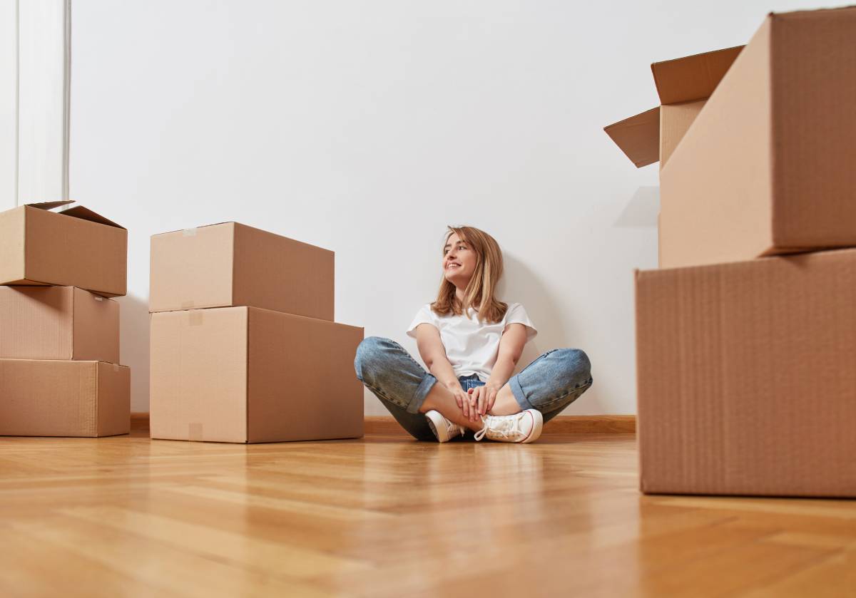a woman surrounded by boxes for moving