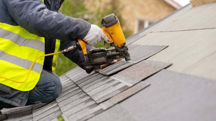 roofer worker installing roof tiles