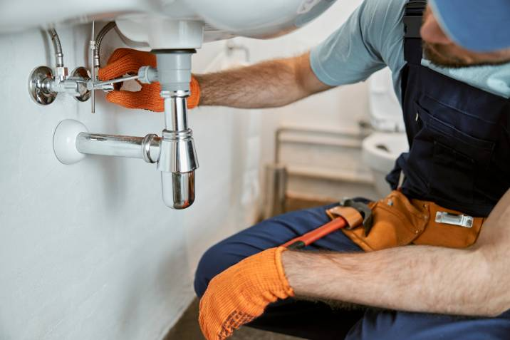 handyman fixing the sink