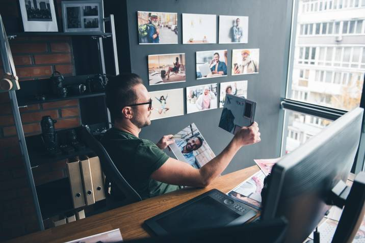 man checking his prints from his work desk