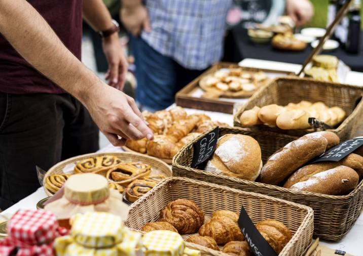 customer choosing from a selection of pastries on the table