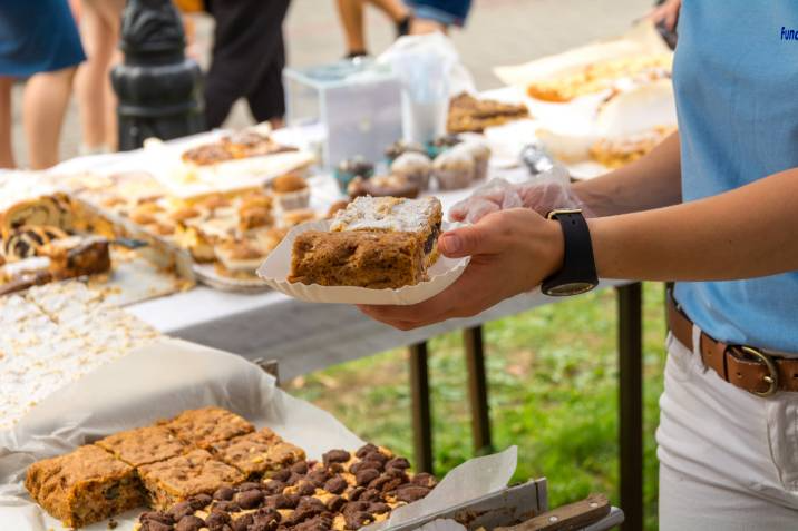 baker serving a slice of cake