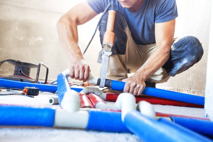 plumber working on pipes