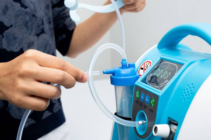 person assembling an oxygen concentrator