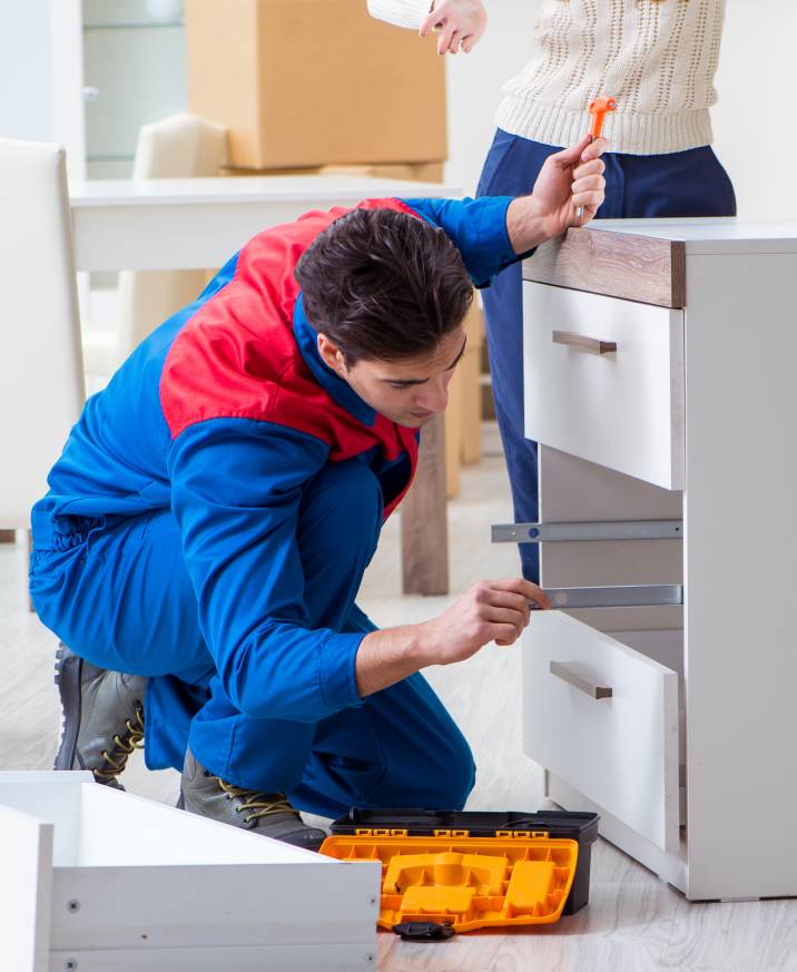 a handyman assembling a small cabinet