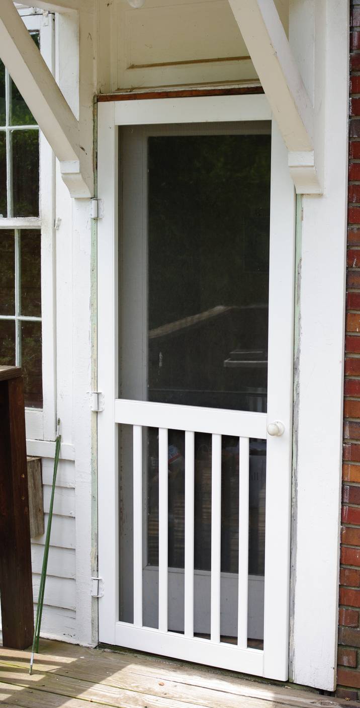 bright white screen door with wooden roofing