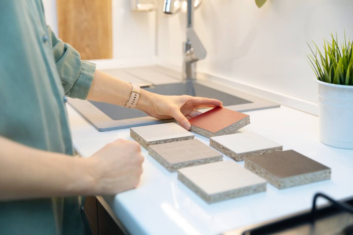 a woman considering countertop material options