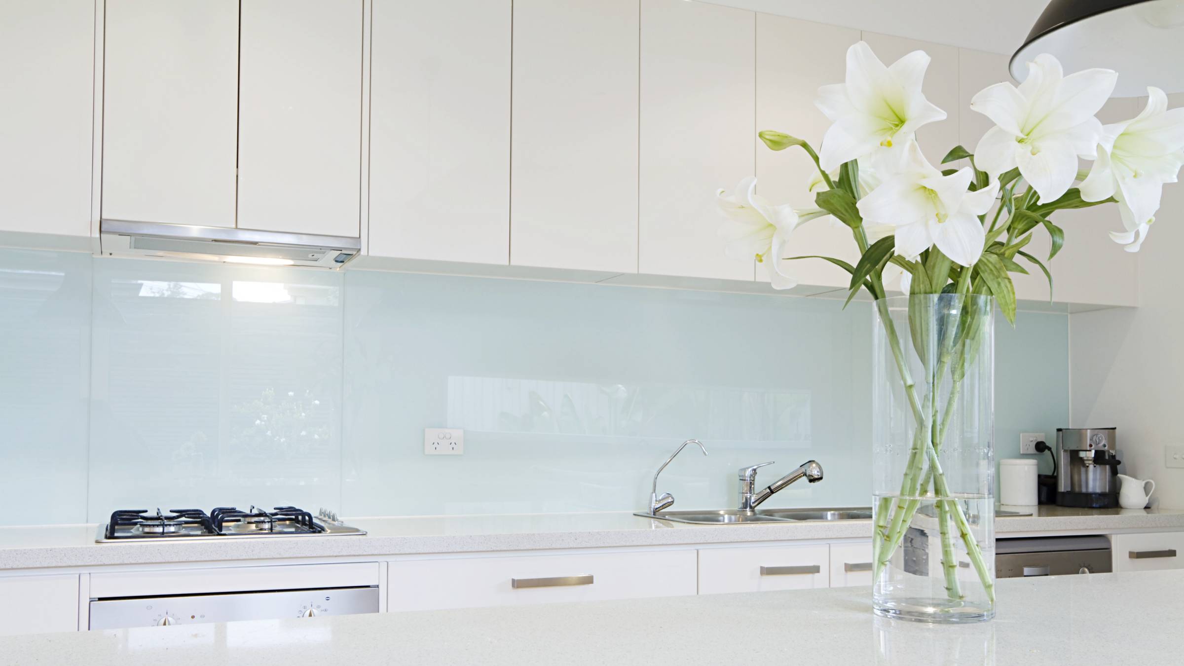 a kitchen with a newly installed glass backsplash