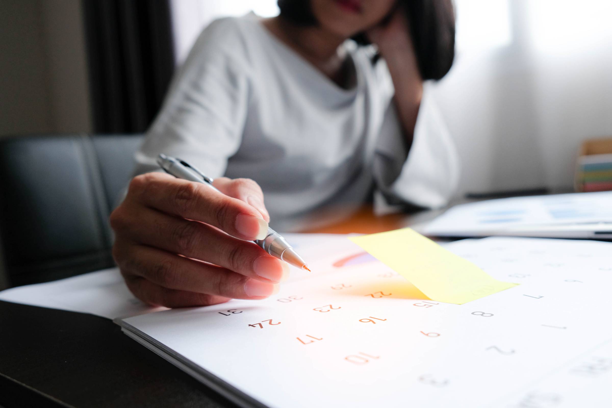 a woman writing a calendar reminder move out cleaning