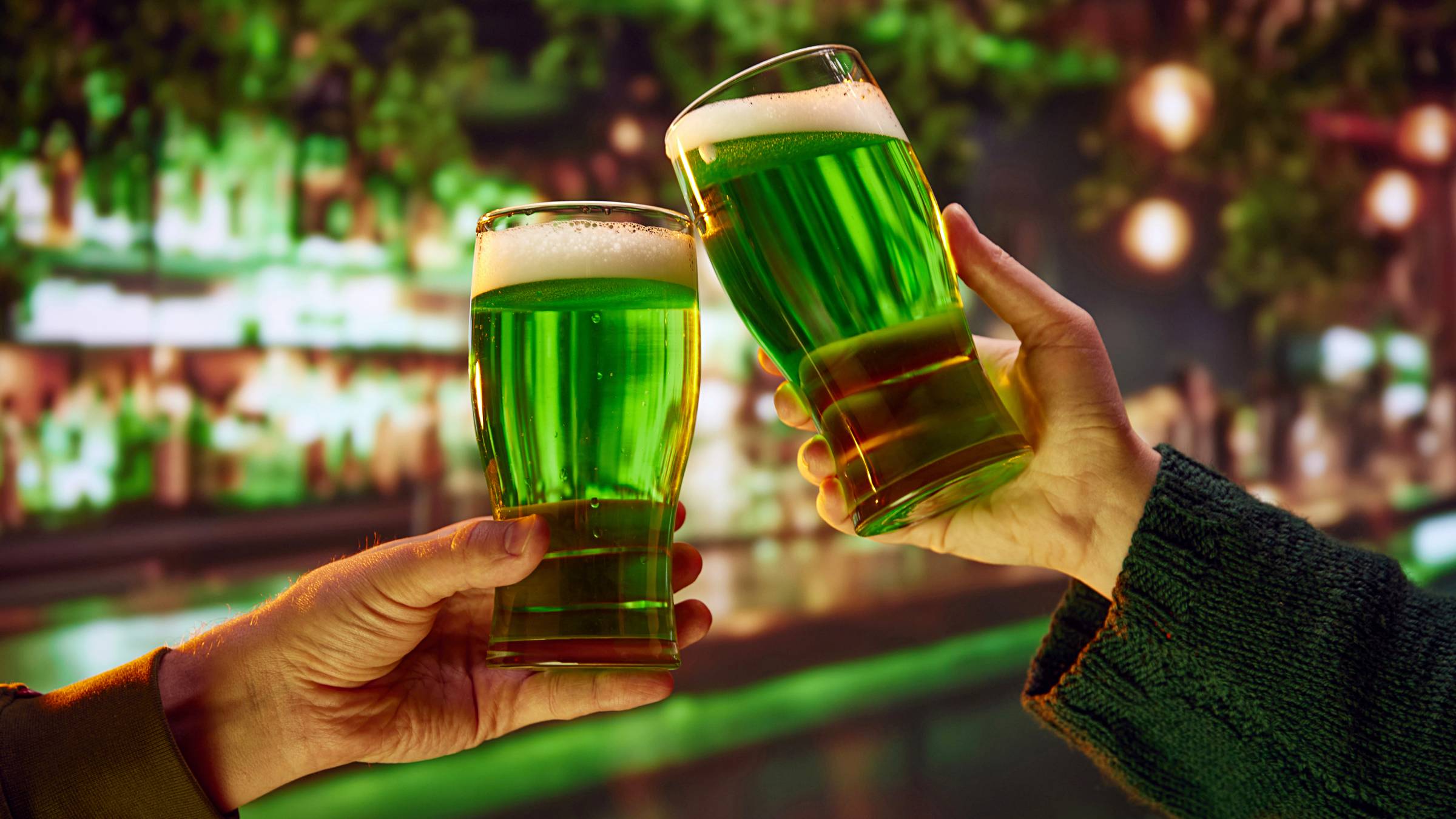two people drinking green craft beer