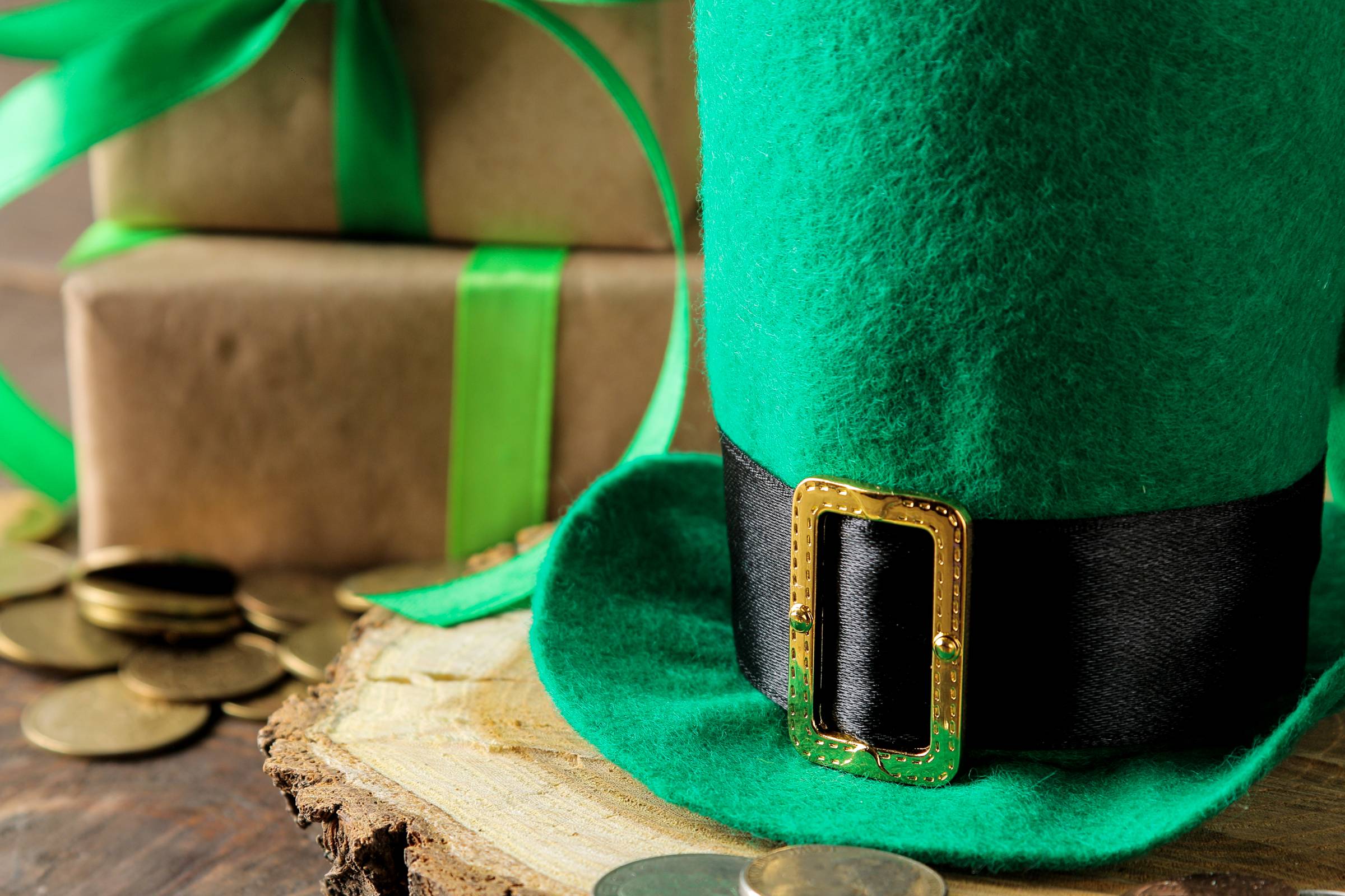 a leprechaun hat beside wrapped gifts