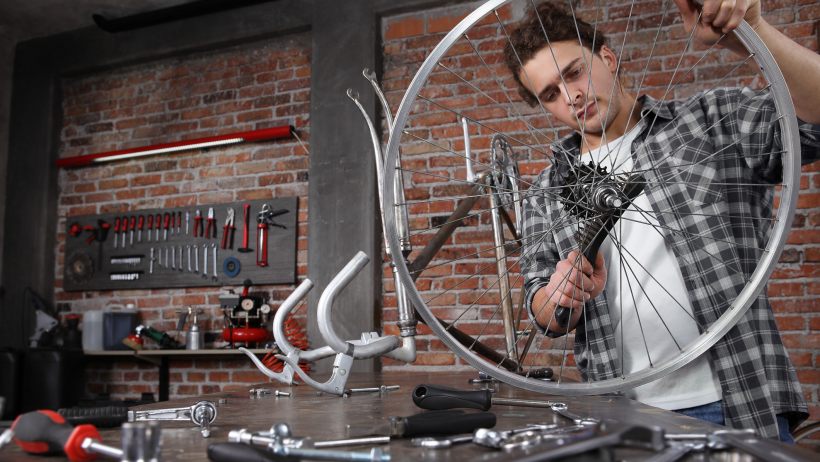 a man showing the assembly process of gravel bike vs road bike