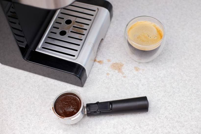 how to clean breville espresso machine - a dirty espresso machine on a kitchen table
