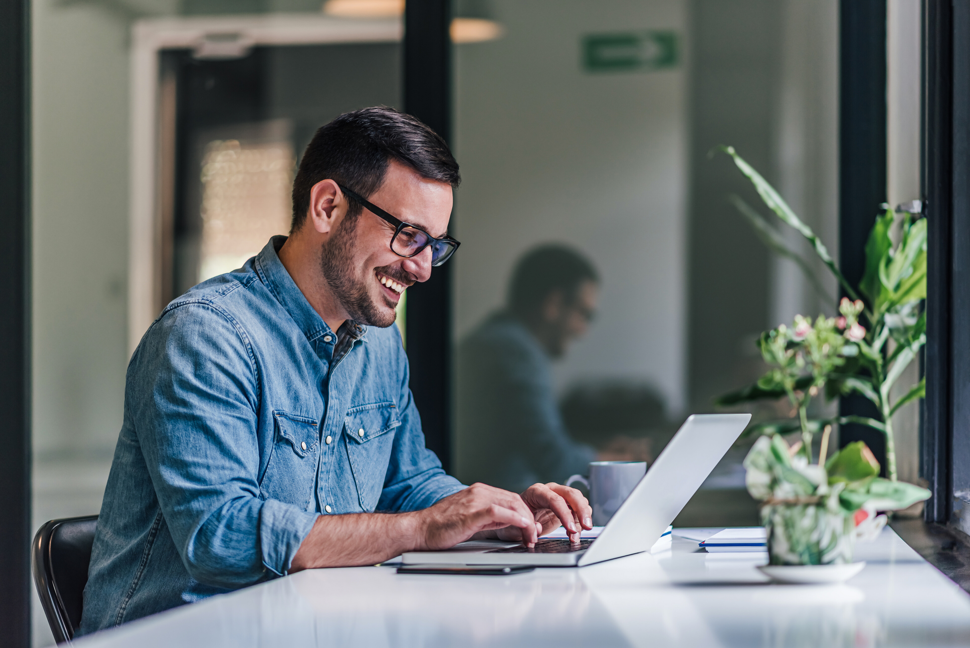 Man smiling while writing a podcast script, scriptwriting to make money 