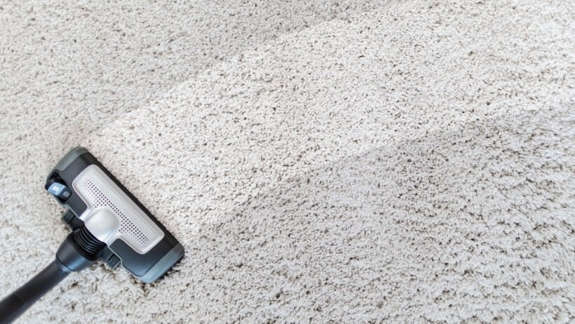 Steam cleaner vs carpet cleaner - a close up of a steam cleaner effectively cleaning a dirty gray carpet