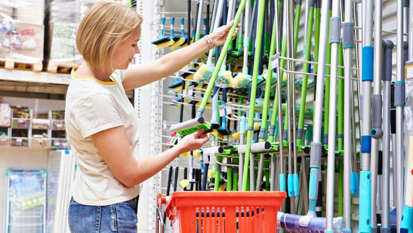 Steam mop, spin mop, or regular mop - a person shopping for a mop in a department store