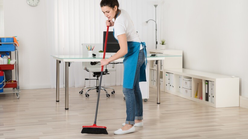 Housekeeper vs cleaner - A housekeeper sweeping a wooden floor