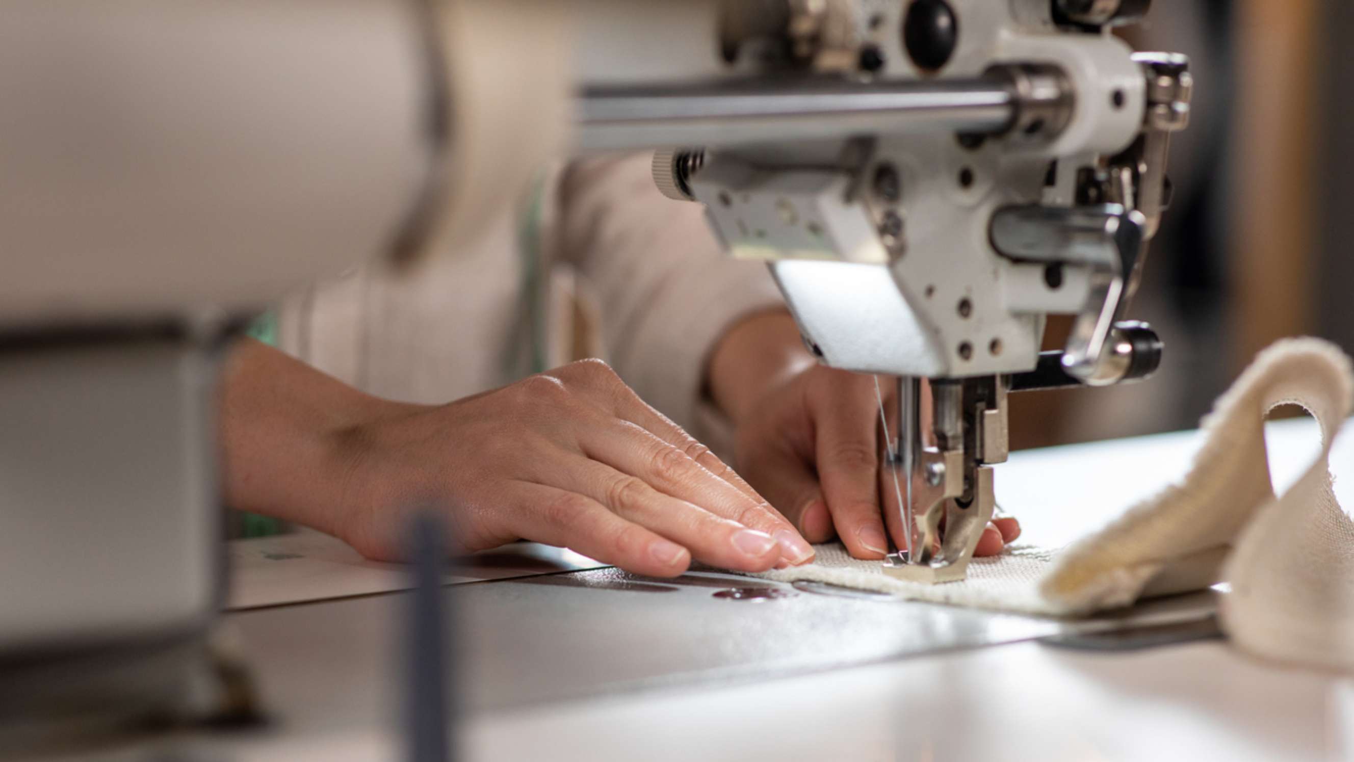 Alterations vs tailoring - An alteration expert using her professional sewing machine to sew a dress