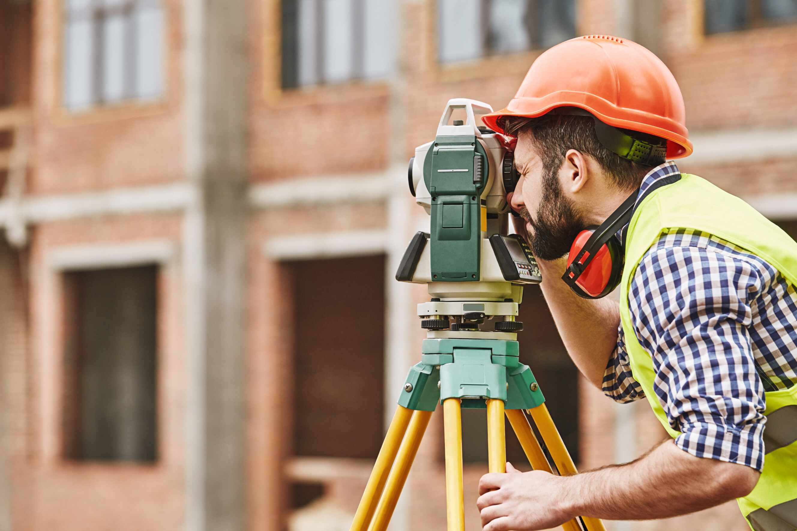 Building surveyor near me inspecting a construction site ensuring structural integrity and compliance with regulations.