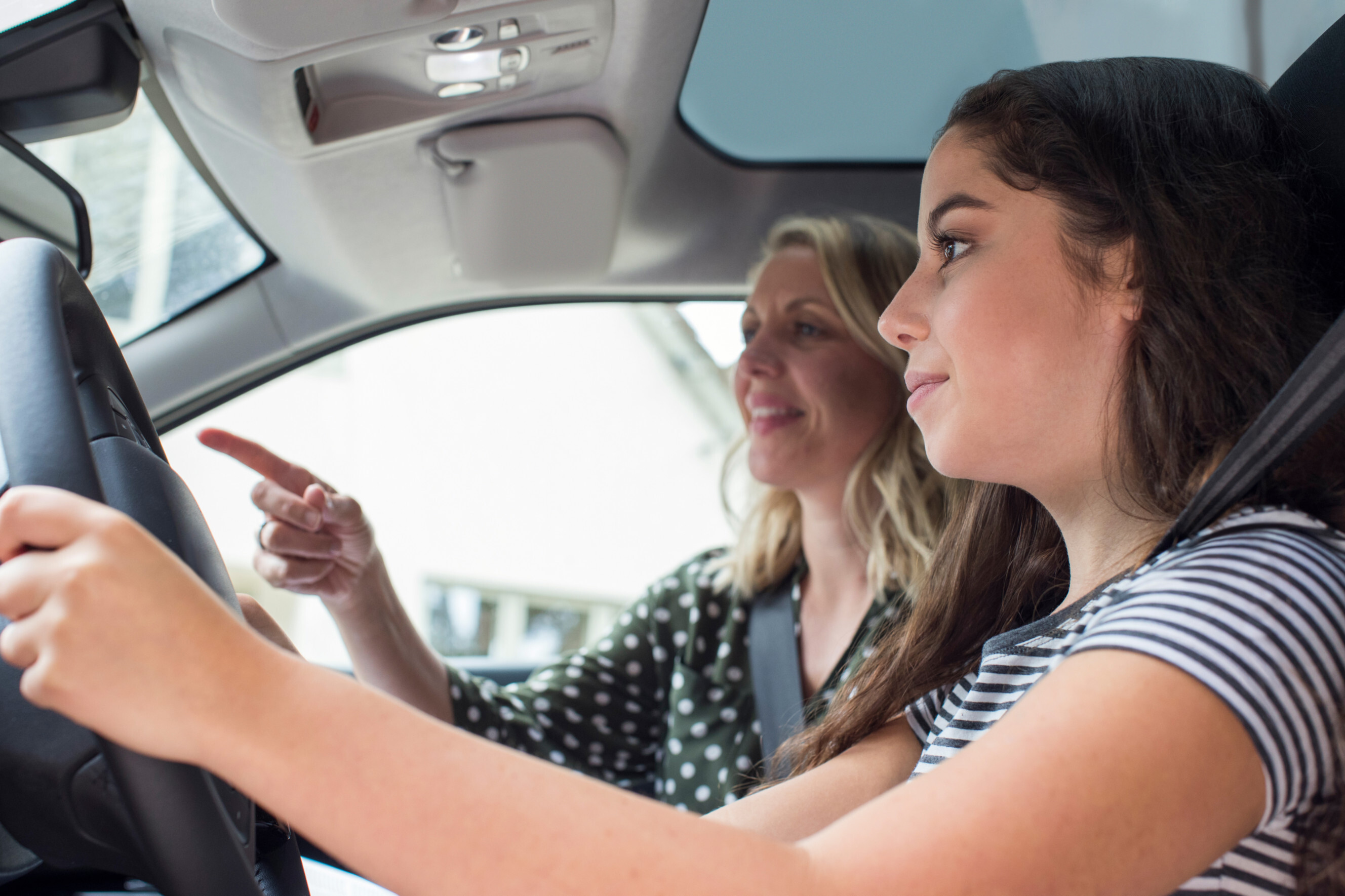 Driving instructor near me guiding a learner driver during a driving lesson.