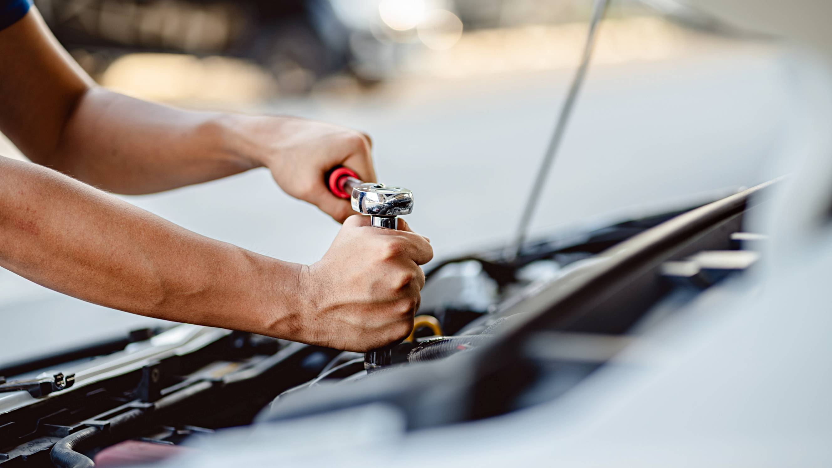 a mechanic preparing to replace a car engine