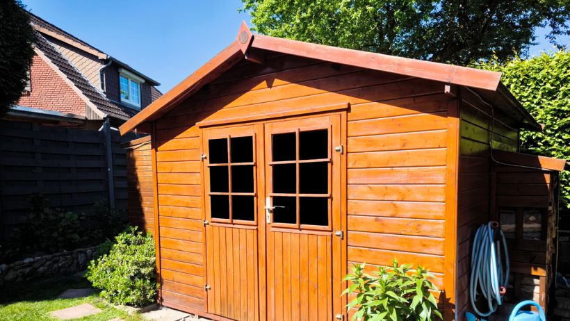 Wooden gable roof shed with double doors and windows