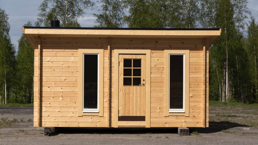 Flat-roof wooden shed with a central door and two tall windows