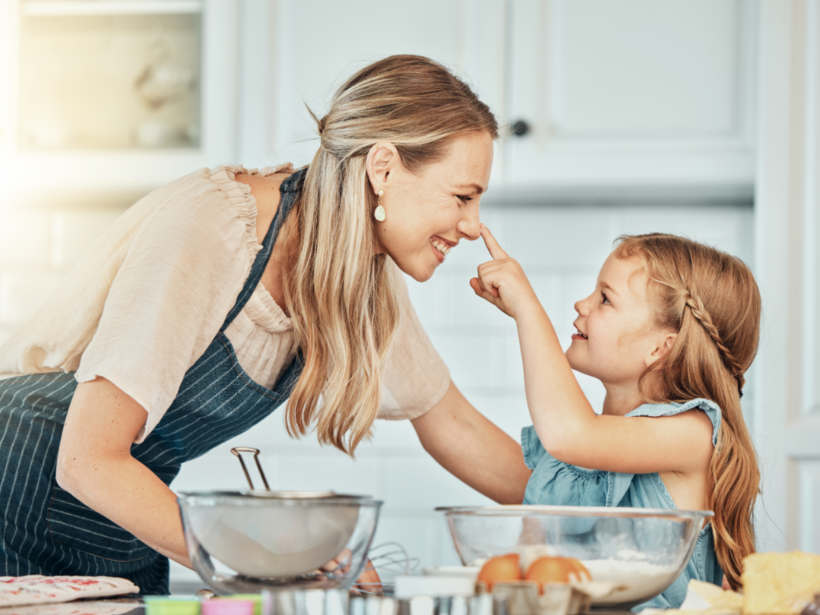 Nanny vs babysitter - A nanny sharing a fun baking moment with a child