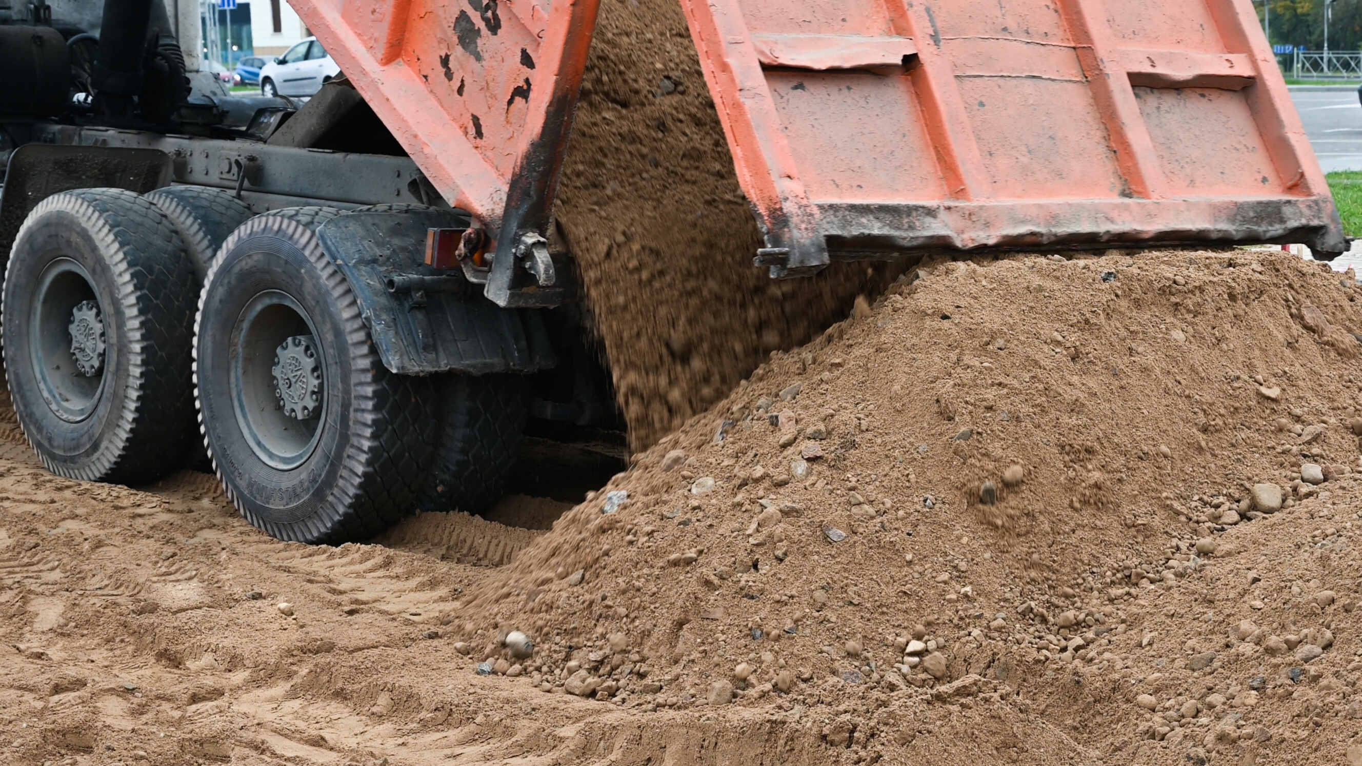 Truck unloading soil for a garden project, highlighting reliable garden center delivery services near you.