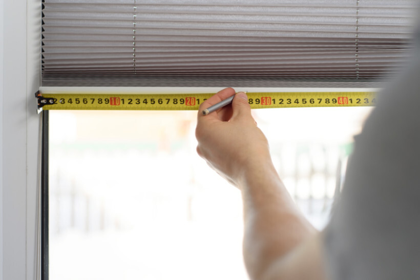 window screen installation - Measuring window blinds for proper fitting during screen installation.