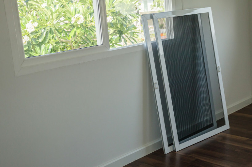 window screen installation - Freestanding window screens ready for installation in a home.