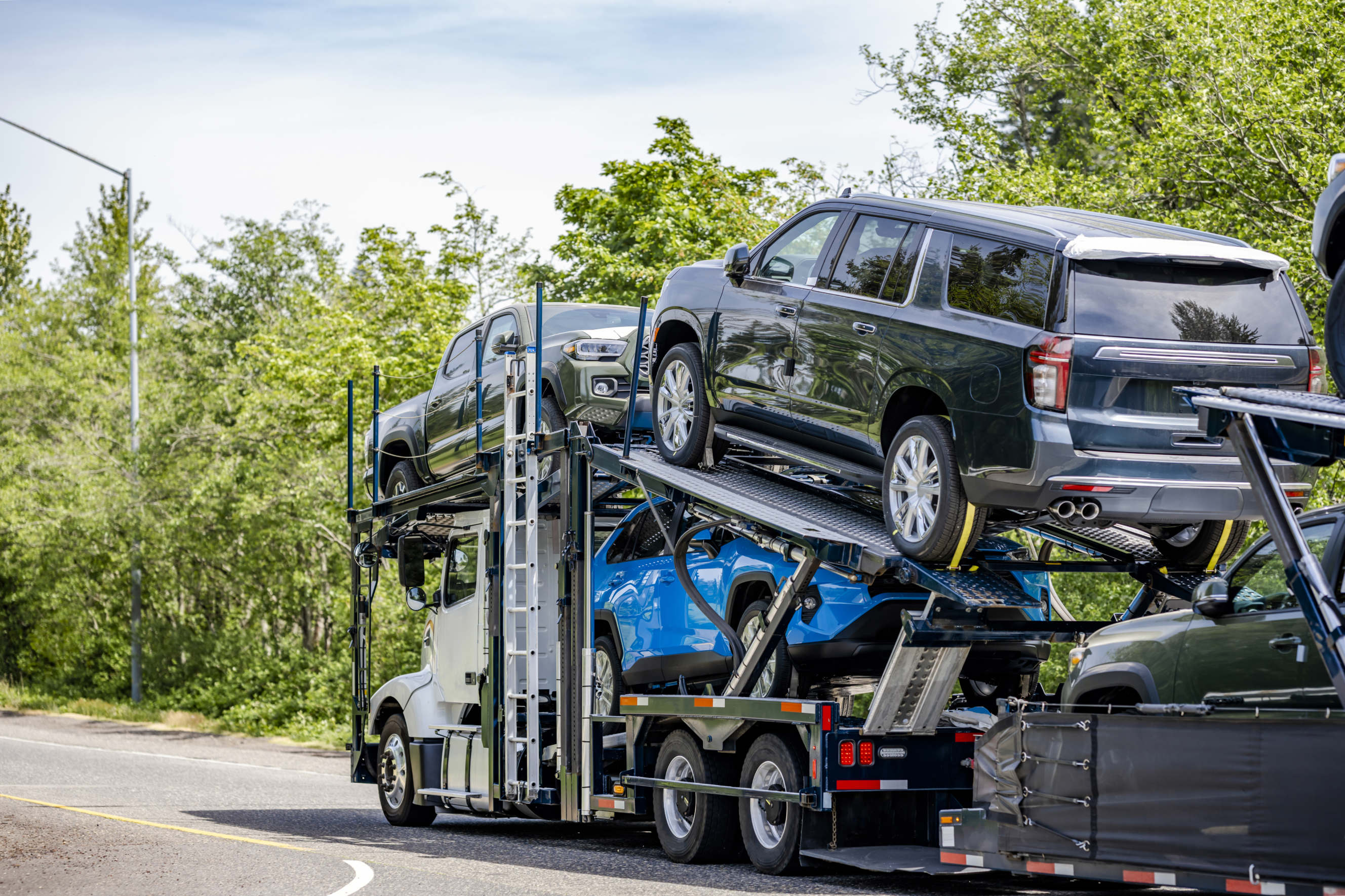 A loaded auto transport trailer delivering vehicles to their destination.