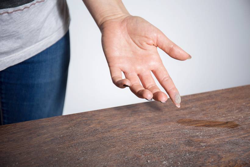 How to stop dust from collecting on desk - a wooden desk with lots of dust