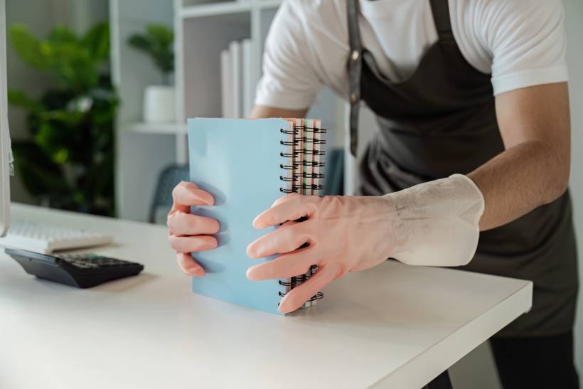 How to stop dust from collecting on desk - a man cleaning a desk