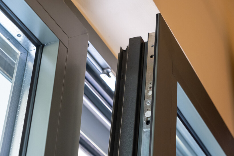 Close-up of a modern aluminum window frame with locking mechanism. - aluminum vs upvc windows