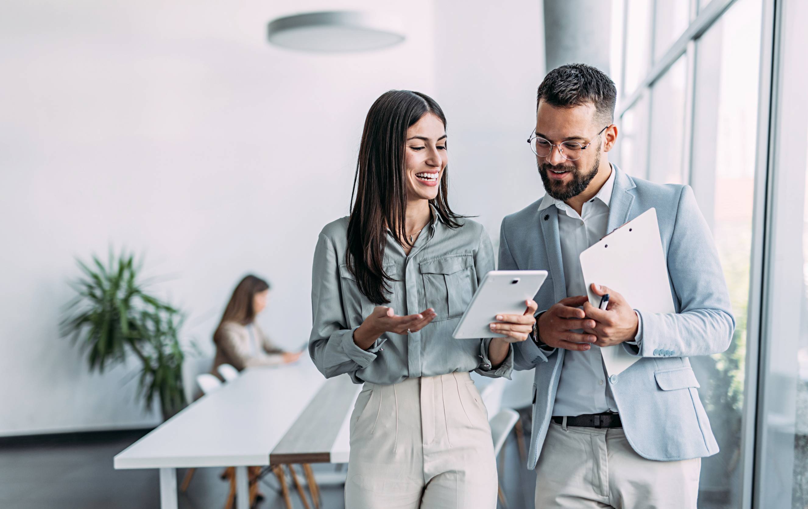 a man and a woman talking to each other in an office