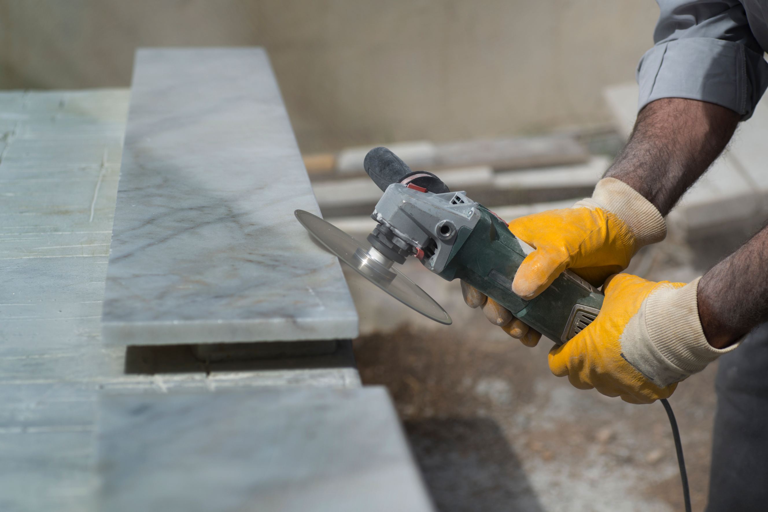 Marble repair with angle grinder representing stone fabricators near me.