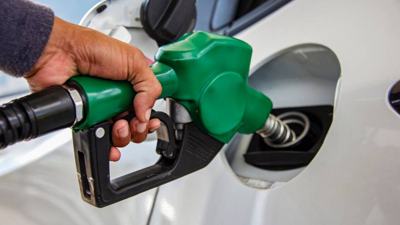 A close-up of a car being refuelled with petrol at a service station. - make money with your car