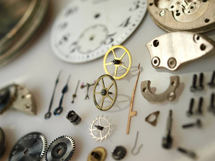 how much does clock repair cost - Various mechanical components of a clock, including gears and hands