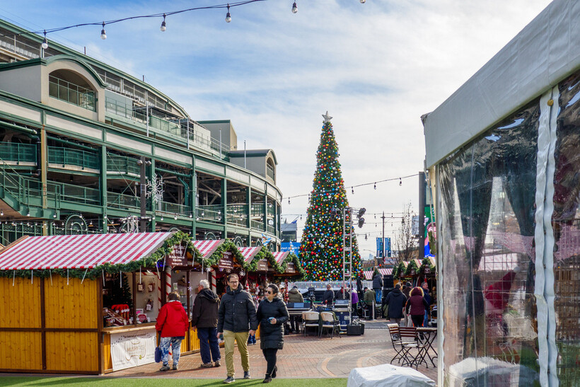 A colorful vintage carousel at a night-time Christmas market with glowing decorative lights. - moving to Chicago